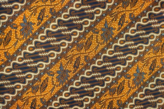 Classic Indonesian batik parang fabric with gold, cream diagonal motifs.