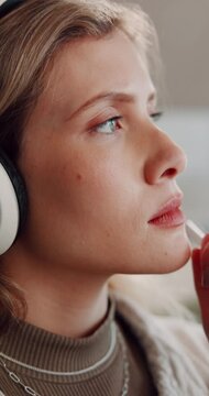 Headphones, thinking and woman in home, relax and listening to music, pen and solution. Contemplation, reflection and person in living room, streaming for audio or song with planning for project