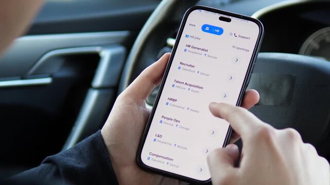 Browsing Finance and HR Jobs on Smartphone. Searching for professional jobs on a mobile app. User scrolls through finance and HR vacancies in a car. Perfect for career growth, remote work, and hiring