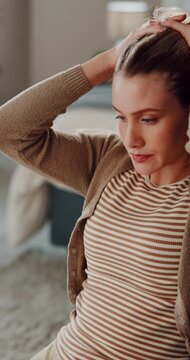 Woman, headache and documents with stress in home for mortgage debt or financial crisis. Frustrated, female person or mistake with paperwork, bills or invoices for rent, bankruptcy or warning notice