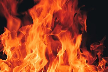 Fototapeta premium Flames Rise Upward in a Dark Space, Creating a Bright and Dynamic Display of Fire