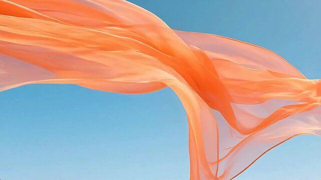 Orange scarf fluttering in blue sky