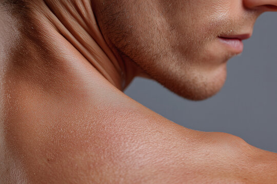 Close up skin texture trapezius soft glow soft lighting male neck shoulder profile with natural pores and fine hair, skincare concept, subtle expression and warm tone