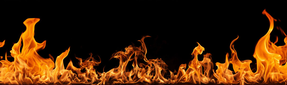 Long burning fire flames background banner on dark black background.