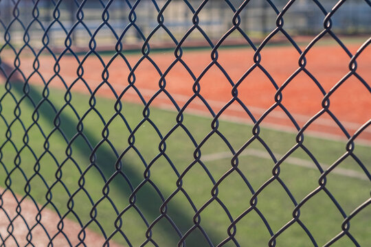 Copy space background baseball field empty public park, close up fence
