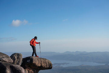 Obraz premium Adventurous hike on rocky summit scenic mountains outdoor activity clear skies dramatic viewpoint nature exploration