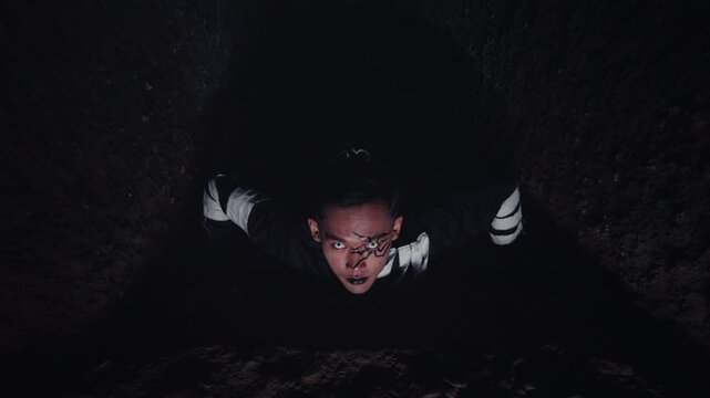 Zoom Out from a Crazed Man Trapped in a Deep Dark Tunnel