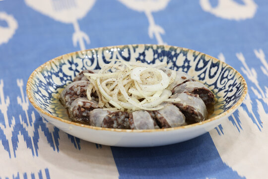 Traditional Uzbek Kazy Blood Sausage with Sliced Onions