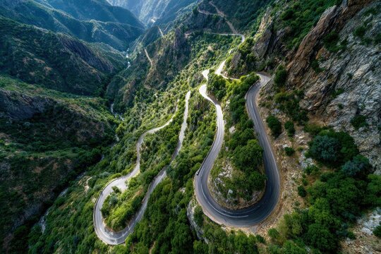 Winding mountain road through lush green valley