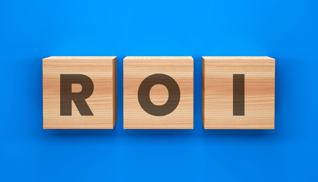 ROI Concept: Wooden blocks spell out ROI against a vibrant blue backdrop, symbolizing return on investment in a clear and engaging manner.