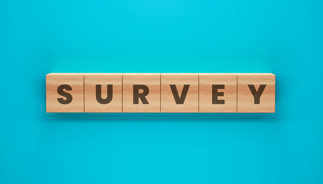 Survey Cubes: Wooden cubes spell out the word SURVEY on a blue background, perfect for use in market research, consumer feedback, and data analysis.