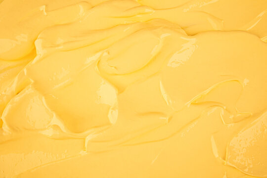 the texture of the pastry cream is yellow. a sample of lemon, banana custard for pastry baking. soft small strokes. top view. a copy of the space.