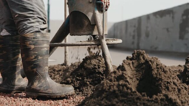 Pouring semi dry screed mix through pneumatic delivery system onto floor