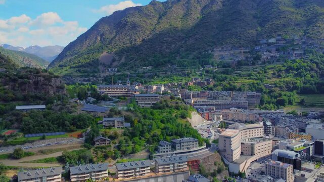 aerial footage showcasing the stunning capital city of Andorra La Vella and the adjacent parish of Escaldes Engordany, nestled within the majestic Pyrenees mountains. This drone shot captures the uniq