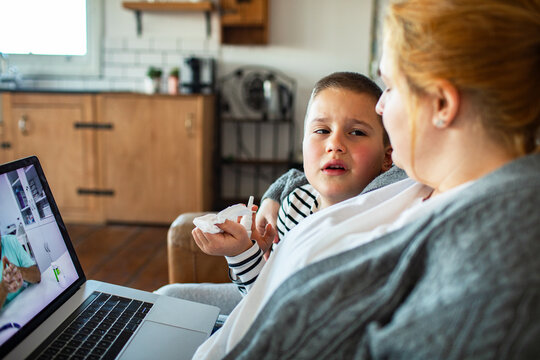 Mother and sick child on telemedicine call at home