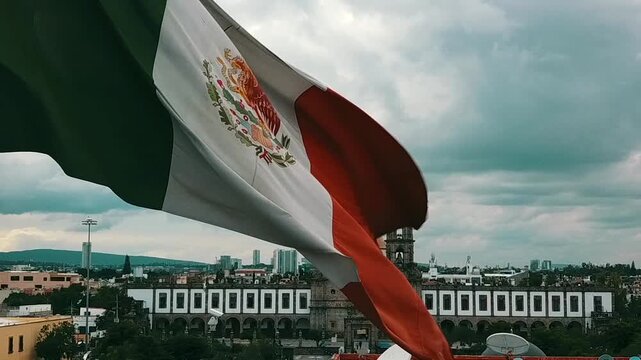 Mexican flag waving in front of the church in the city of Guadalajara, land of tequila 