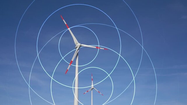 visualization of invisible sound waves around two rotating wind turbines, set against a blue sky, live-action video combined with animation, symbolic noise pollution