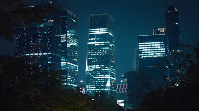 Bangkok skyscrapers skyline illuminated at night with modern glass towers, Night cityscape with highrise buildings and glowing urban business district 4k