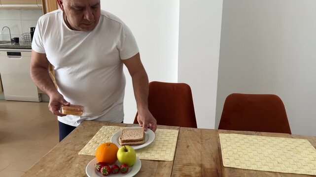 Hombre saliendo de la cocina y sent&aacute;ndose a desayunar