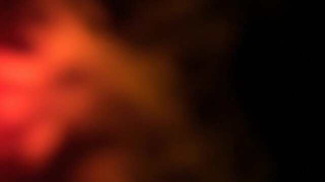 Blurry orange light on black background.