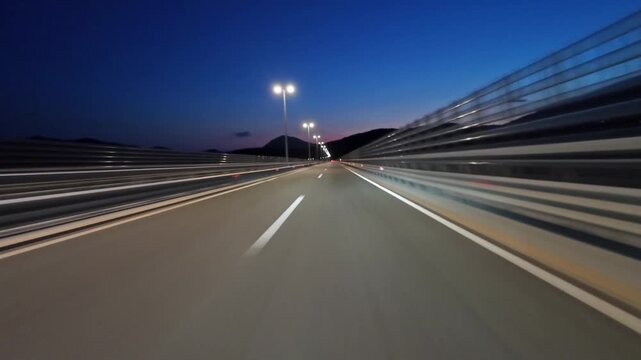 POV driving on modern highway with bright lights illuminating the road at night. Transportation, travel and infrastructure concept, 4k