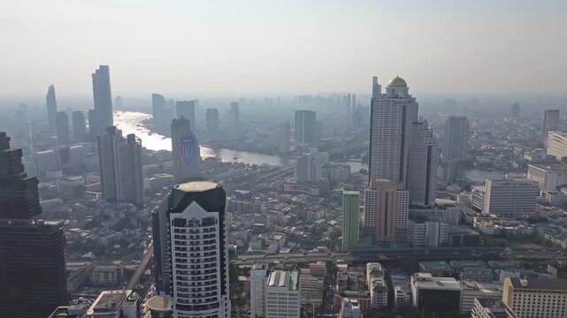 Aerial high view of Bangkok city, urban skyscrapers and office buildings in business district, Thailand, 4k