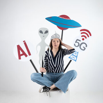 Woman expressing paranoia about ai, aliens, ufos, and 5g with a tin foil hat