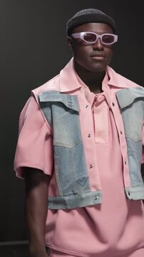 Fashion model, man and walk with sunglasses on runway for style showcase, couture or designer brand. Catwalk show, audience and trendy wardrobe on stage for clothes collection, menswear or confidence