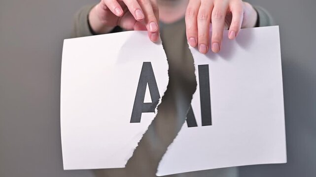 A person male, in their 20s, tears a sheet of paper with the letters AI printed on it. The action signifies the relationship between artificial intelligence and creativity in a simple, visual manner