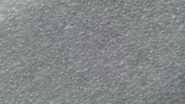 White color bubble wrap sheet closeup abstract background texture. Stop motion animation loop.