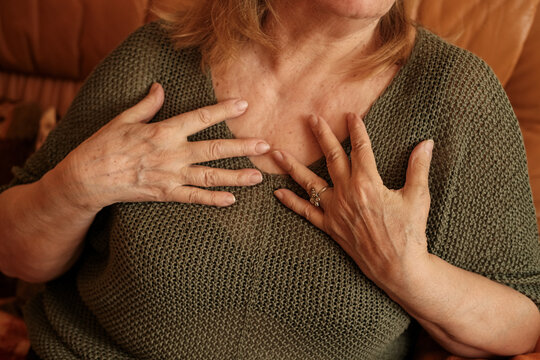 Elderly woman hands. Senior old lady experiencing severe arthritis rheumatics pains, massaging, wrinkles, veins, warming up arm. Close-up.