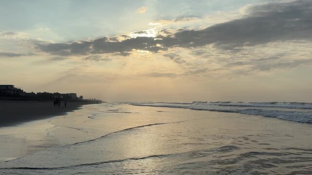 El Pared&oacute;n, Guatemala, is a serene black sand beach with crashing Pacific waves, palm trees, surfers, and breathtaking golden sunsets.