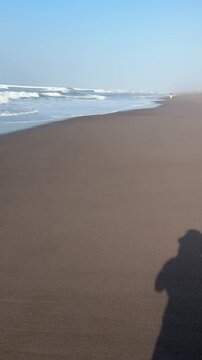 El Pared&oacute;n, Guatemala, is a serene black sand beach with crashing Pacific waves, palm trees, surfers, and breathtaking golden sunsets.