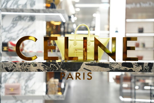 Celine Paris golden brand logo and handbag in a luxury boutique.