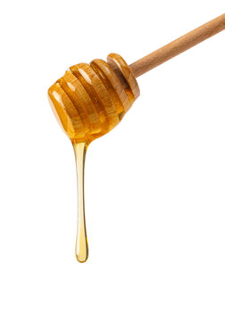Wooden honey dipper dripping golden sweet natural honey