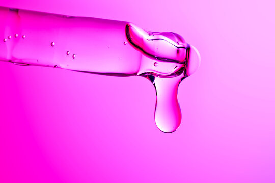 Peptide serum dropping from pipette for advanced skincare