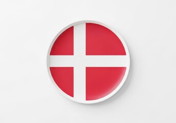 Fototapeta premium A circular plate featuring the flag of denmark isolated on white background