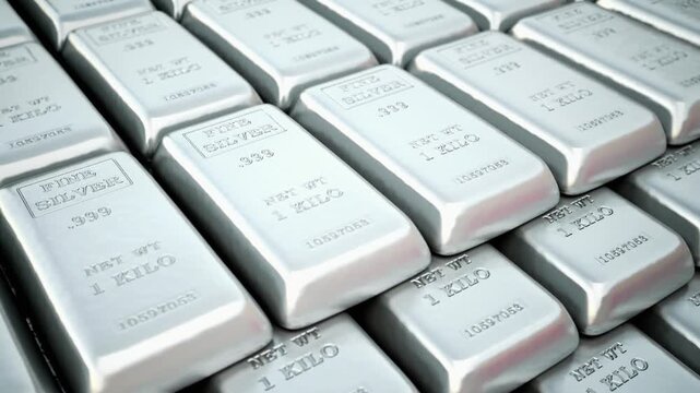 Shiny silver bars stacked together representing wealth, financial security, and precious metal investment. The metallic texture and reflective surface create a professional finance and economy concept
