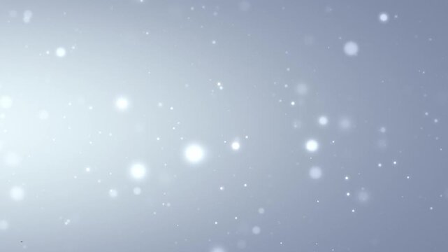グレーのグラデーション背景に、丸ボケが星のようにキラキラと輝く、パーティクルの光の背景アニメーション