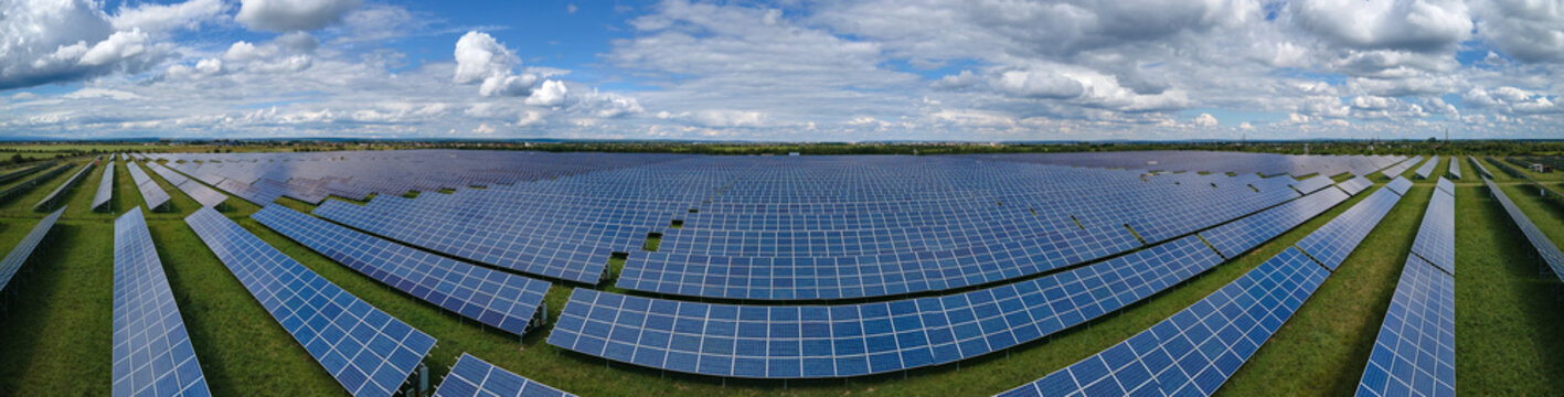 Aerial view of big sustainable electric power plant with many rows of solar photovoltaic panels for producing clean electrical energy. Renewable electricity with zero emission concept