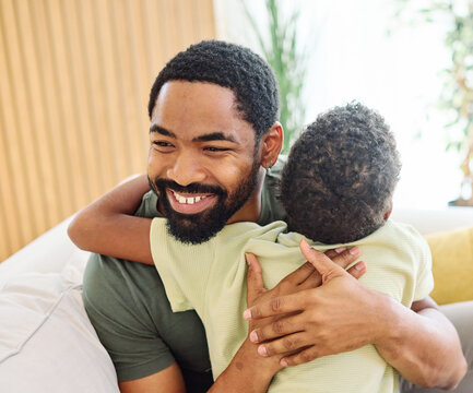 Portrait of a happy teenage boy son and his father at home. Sharing secrets and having fun, support and parenthood concept