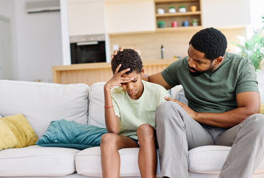 Portrait of a teenage boy son talking to his father at home. Sharing secrets and problems, support and parenthood concept