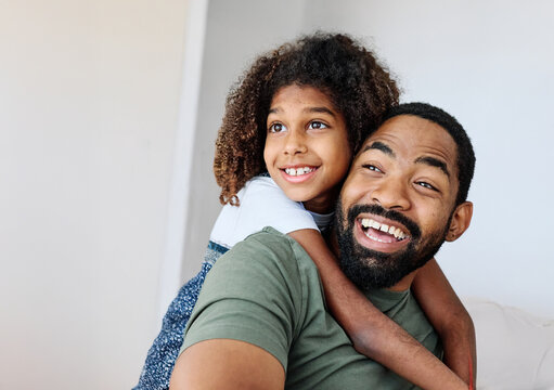 Portrait of a happy black family  father and kid girl daughter having fun bonding at home