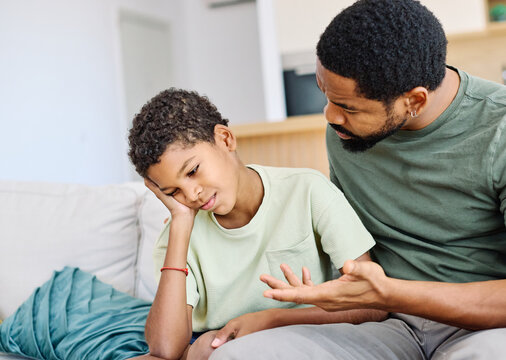 Portrait of a teenage boy son talking to his father at home. Sharing secrets and problems, support and parenthood concept