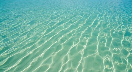 Fototapeta premium Crystal clear turquoise water surface with dancing sunlight reflections