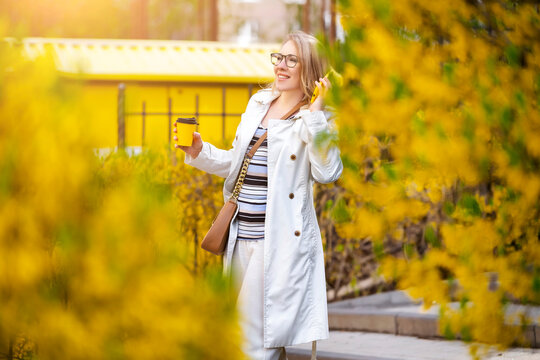 Woman walking with coffee. Lively rhythm, urban pulse and radiant positive energy.