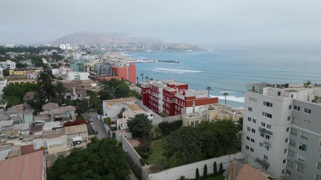 Beautiful aerial video of Barranco coastal district in Lima, Peru, with ocean views on a cloudy autumn day.