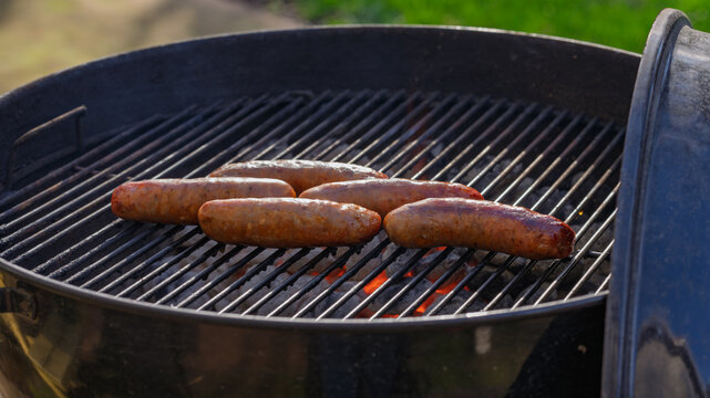 Sausage grill outside on trill in a backyard