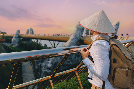 Man traveler tourist at golden bridge, ba na hills, Da nang, Vietnam sunset view