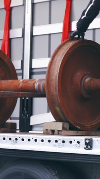 Worker navigate forklift while loading cargo on truck trailer slow motion